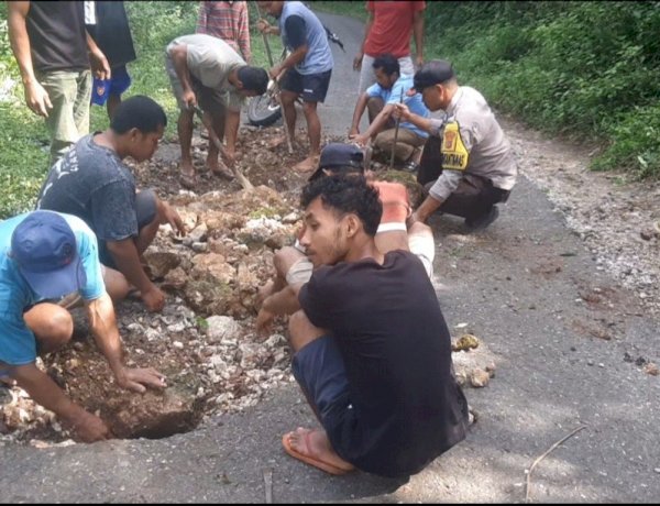 BHABINKAMTIBMAS REOK BARAT BERSAMA WARGA GELAR KERJA BHAKTI TAMBAL JALAN DI KAMPUNG RUMUNG