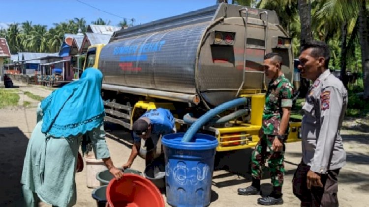Personel Polsek Reo Bantu Penyaluran Air Bersih kepada Warga Desa Paralando
