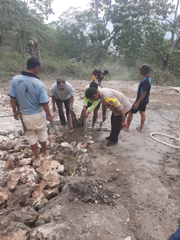 Bhabinkamtibmas Reok Barat Bersama Warga Gelar Kerja Bhakti Perbaiki Jalan Rusak